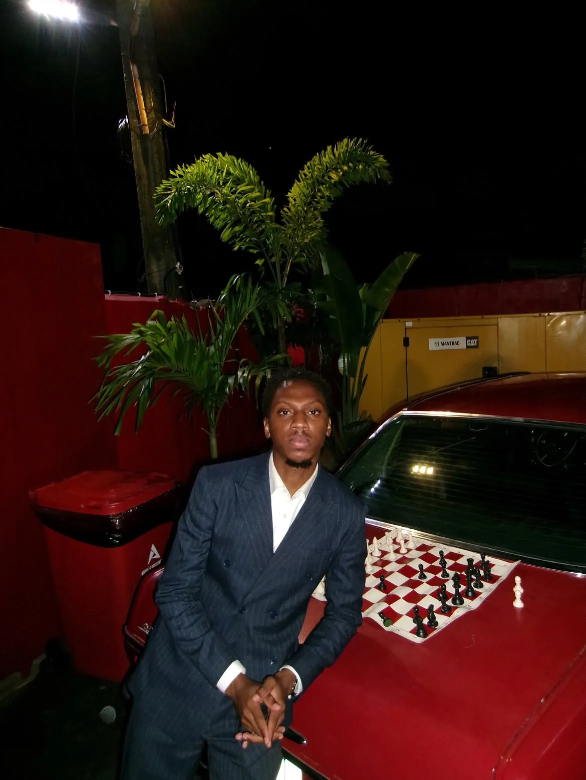 A guest beside the chessboard on a red car