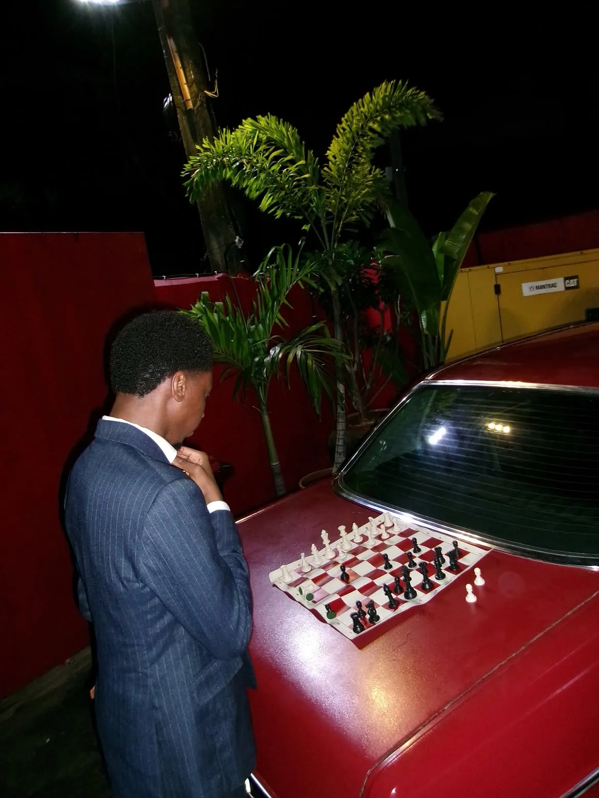 A player studying the chessboard on a car