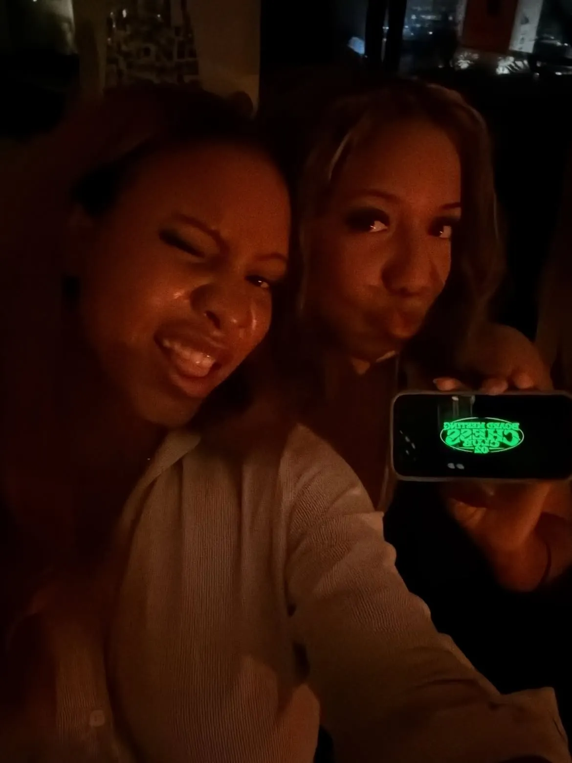 Two guests displaying the green club insignia
