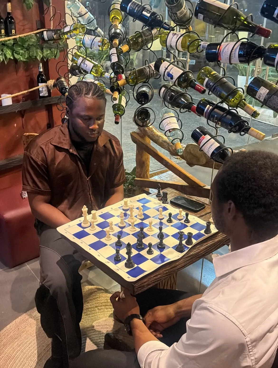 A player making a move beside the bottle display
