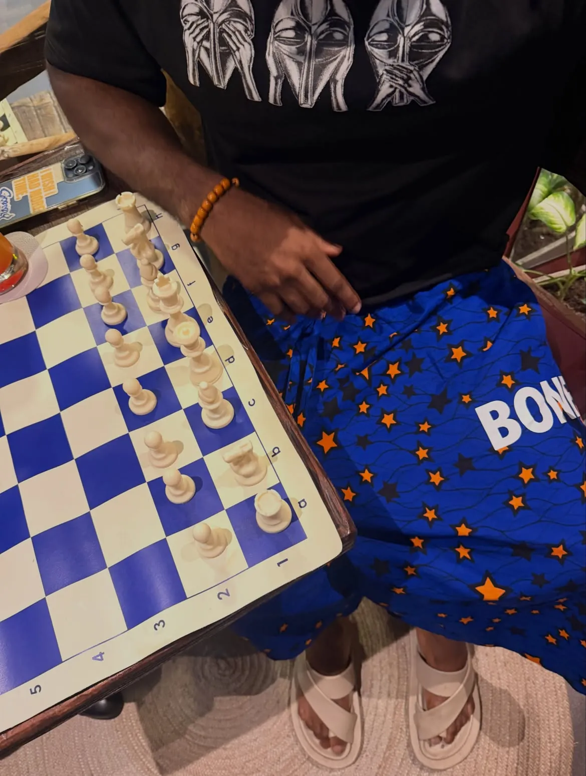 A close-up of a purple and cream chessboard